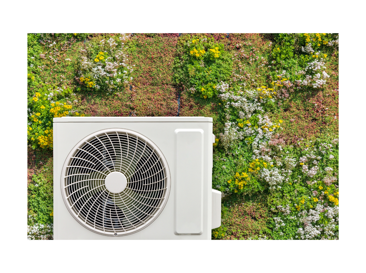 Air-source heat pump mounted against a green living wall